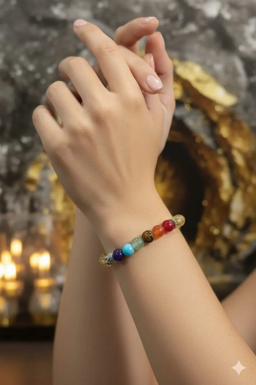 Close-up of a hand wearing a colorful beaded bracelet against a warm, blurred background.